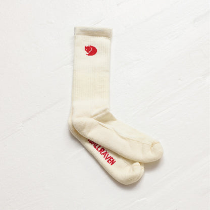 White socks with red logo and text on a white background